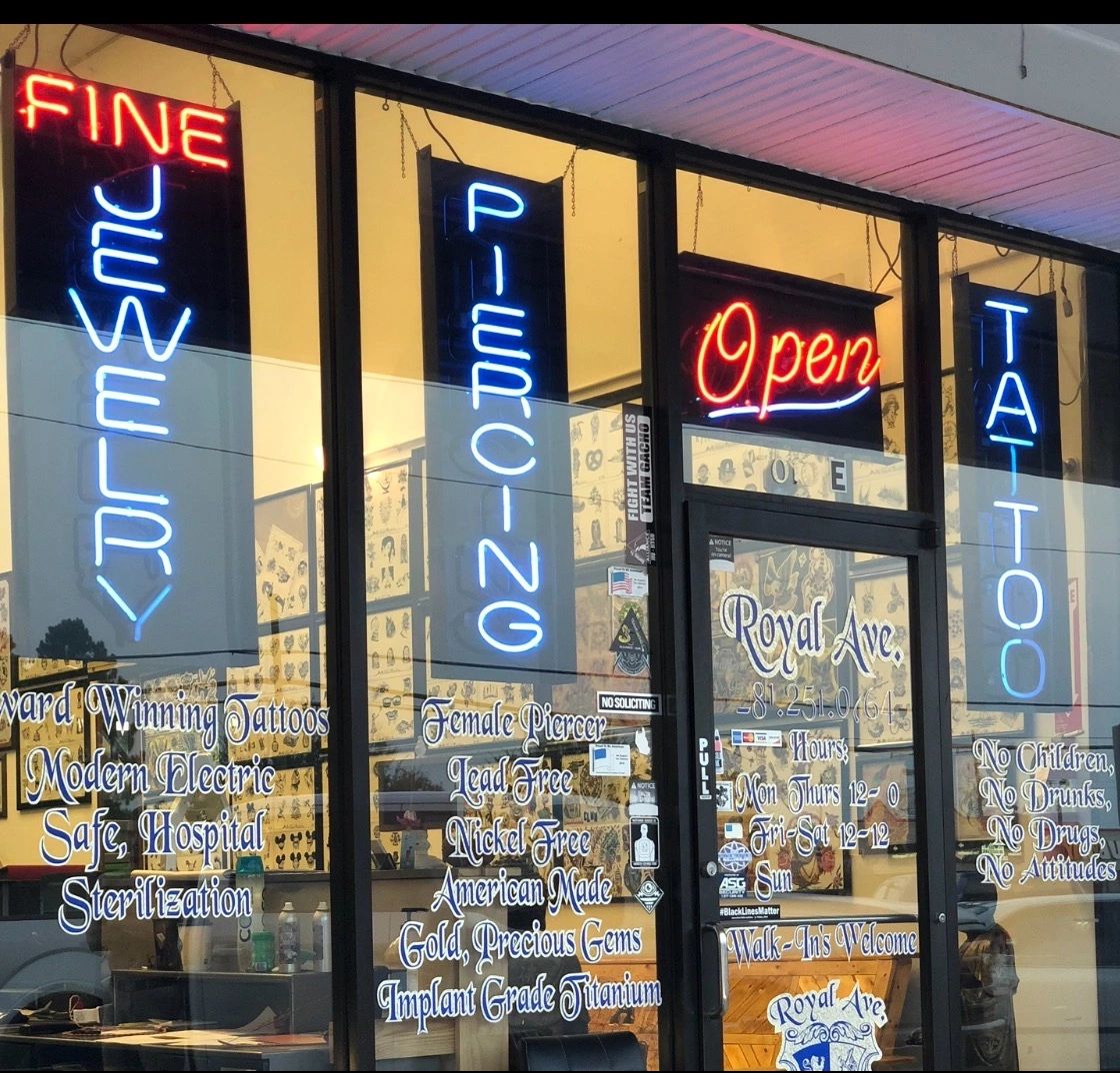 Royal Ave Tattoo storefront with neon signs
